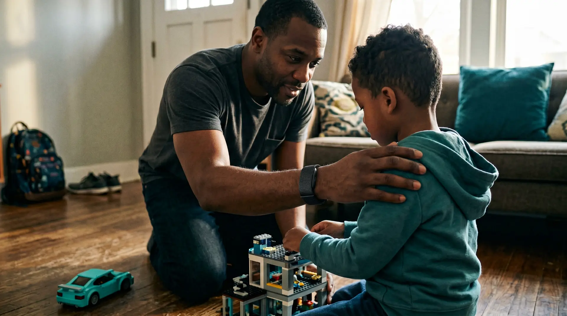 Father and son building with blocks on the living room floor